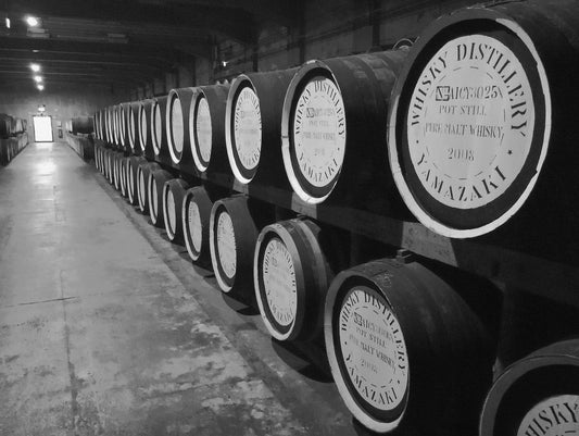 Why are oak barrels important for aging whisky and rum?